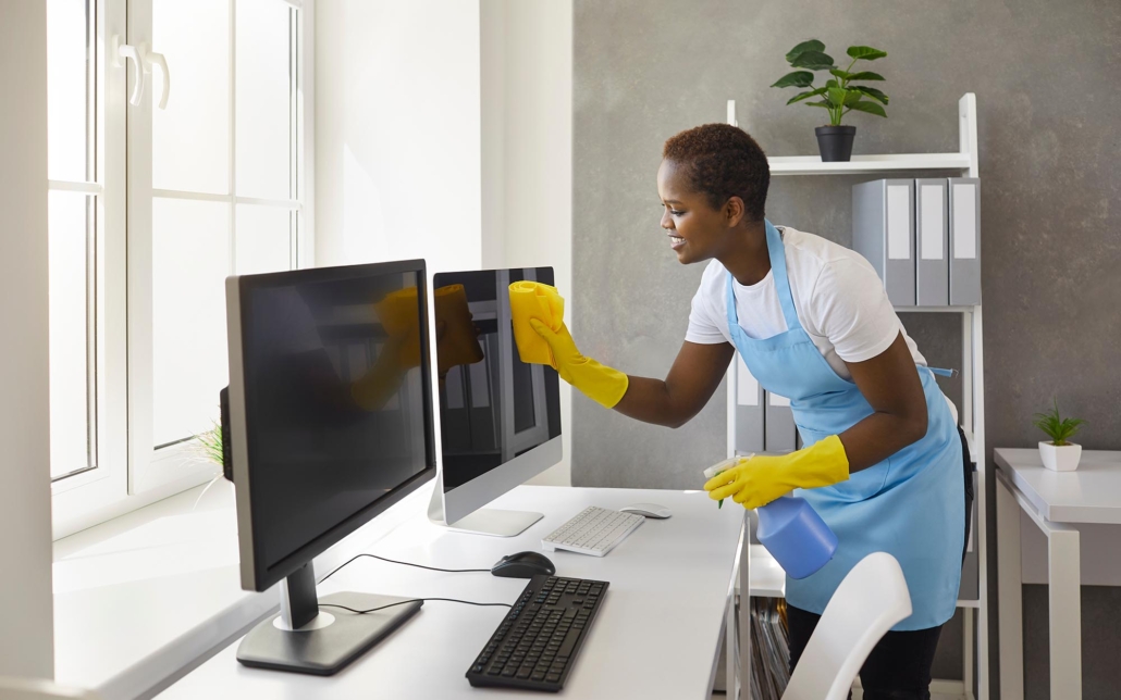 Janitorial Worker Cleaning Office Desk Space