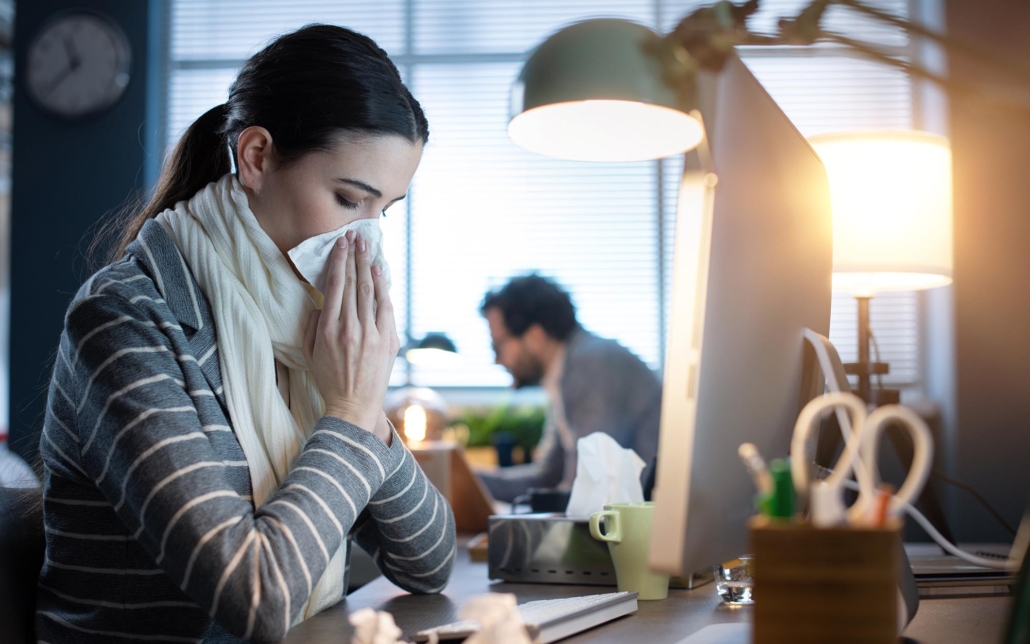 Person In Office Blowing Their Nose