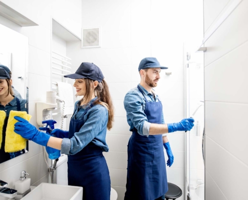 Two Janitorial Workers Cleaning Commercial Bathroom