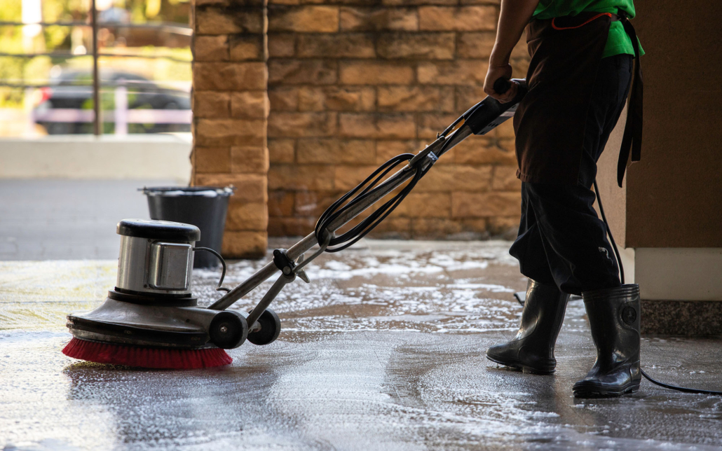 A Man Worker Cleaning The Floor With Polishing Machine