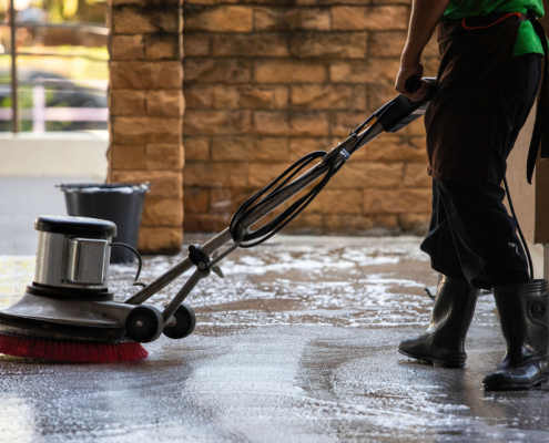 A Man Worker Cleaning The Floor With Polishing Machine